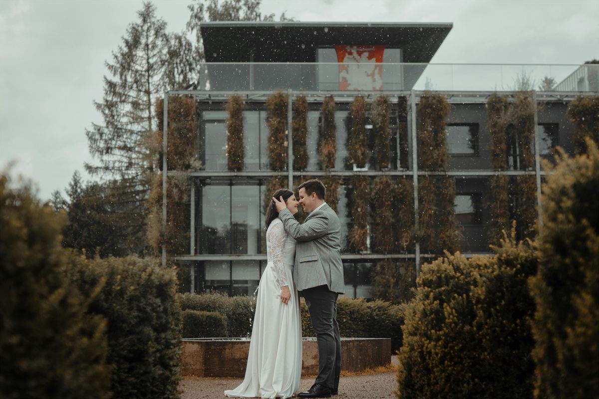 Brautpaar vor moderner Architektur in ruhiger, editorialer Hochzeitsästhetik