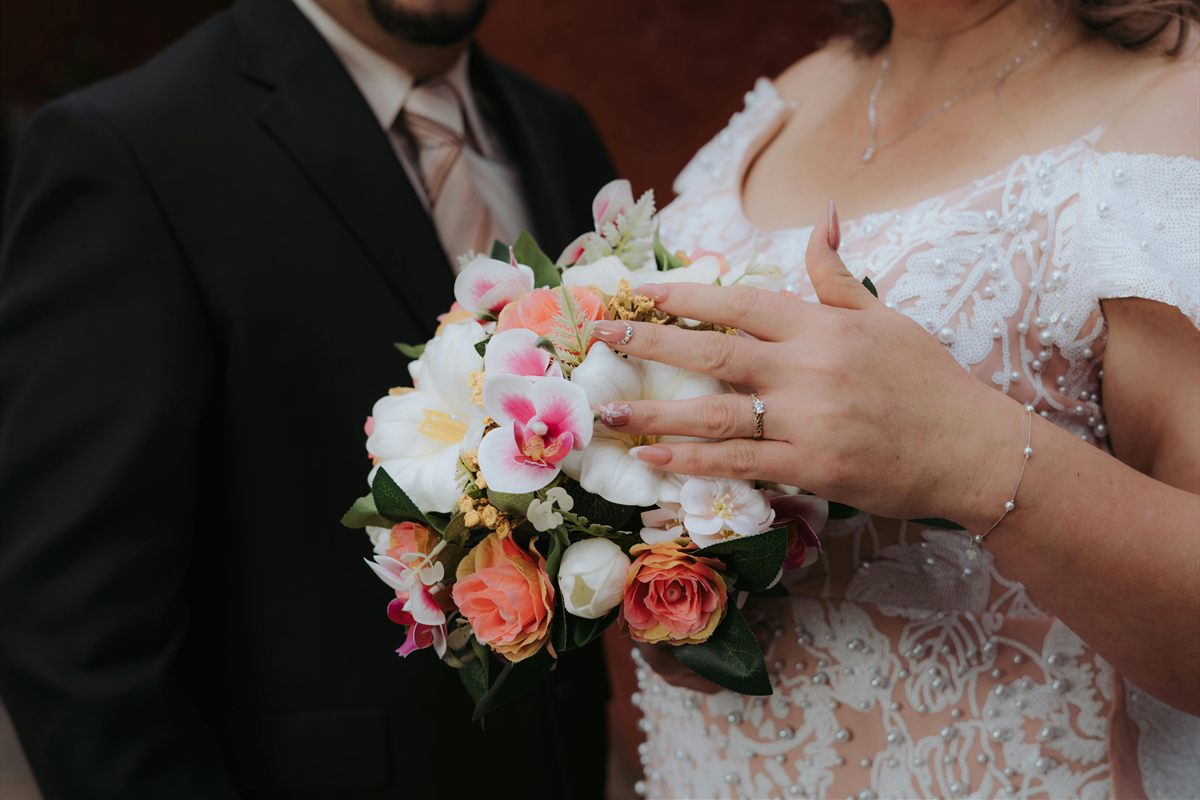 Braut mit Brautstrauß und sichtbarem Ehering bei der standesamtlichen Trauung